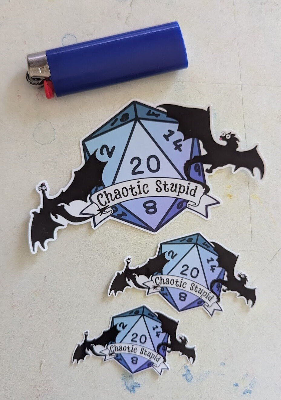 Chaotic Stupid d20 | crit success | silhouette | dragon in flight | waterproof | vinyl | laminated